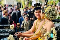 Sepasang pengantin Kaesang Pangarep dengan Erina Gudono berada di atas kereta kuda dikirab dari Loji Gandrung rumah dinas Wali Kota Solo menuju Puro Mangkunegaran
