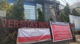 Salah satu objek Yayasan STIMIK IGM yang dipasang plang banner. [Ist]